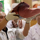A staff member holds up a cut. (EPA/Kiyoshi Ota)